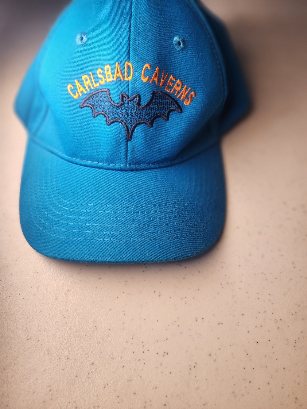 Carlsbad Caverns Teal Blue Baseball Cap with Bat Logo